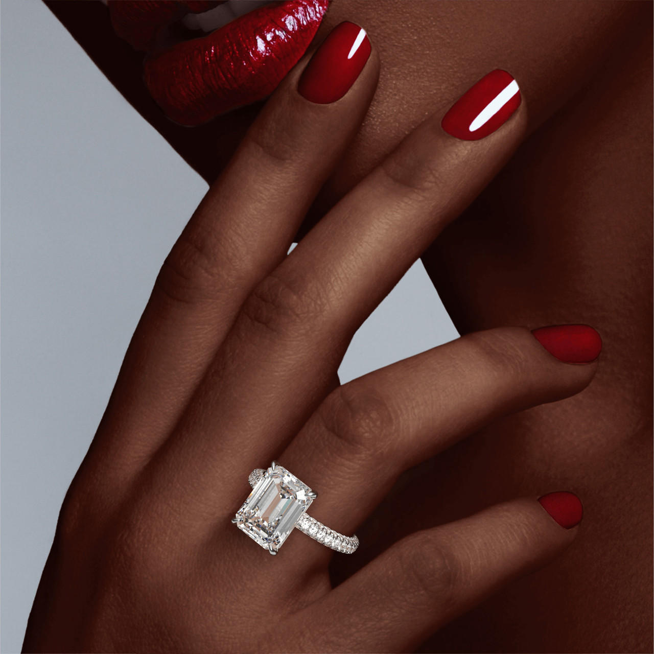 EMERALD CUT DIAMOND ENGAGEMENT RING WITH A CLASSIC 4 PRONG THREE PHASES TRIPLE PAVE SETTING IN PLATINUM