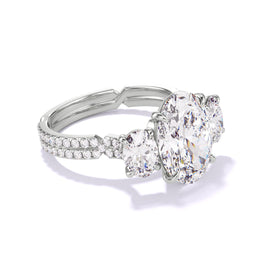 OVAL CUT DIAMOND ENGAGEMENT RING WITH A THREE STONE CHANCE PAVE SETTING IN PLATINUM
