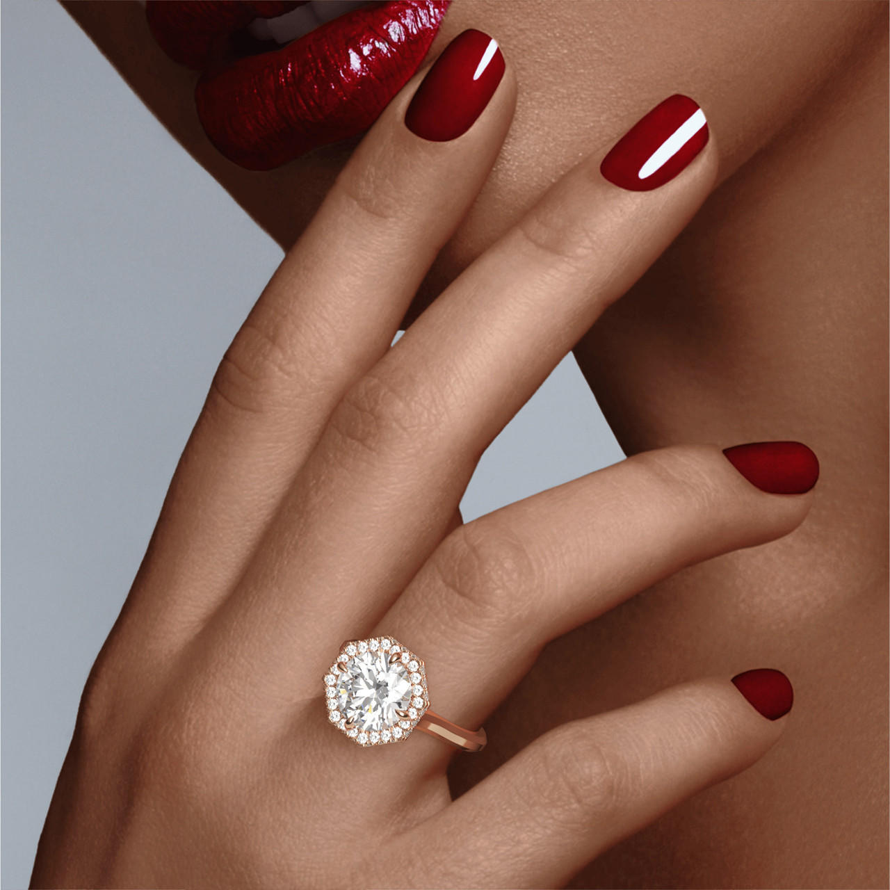 Round Halo Ring in rose gold with a thin band on hand