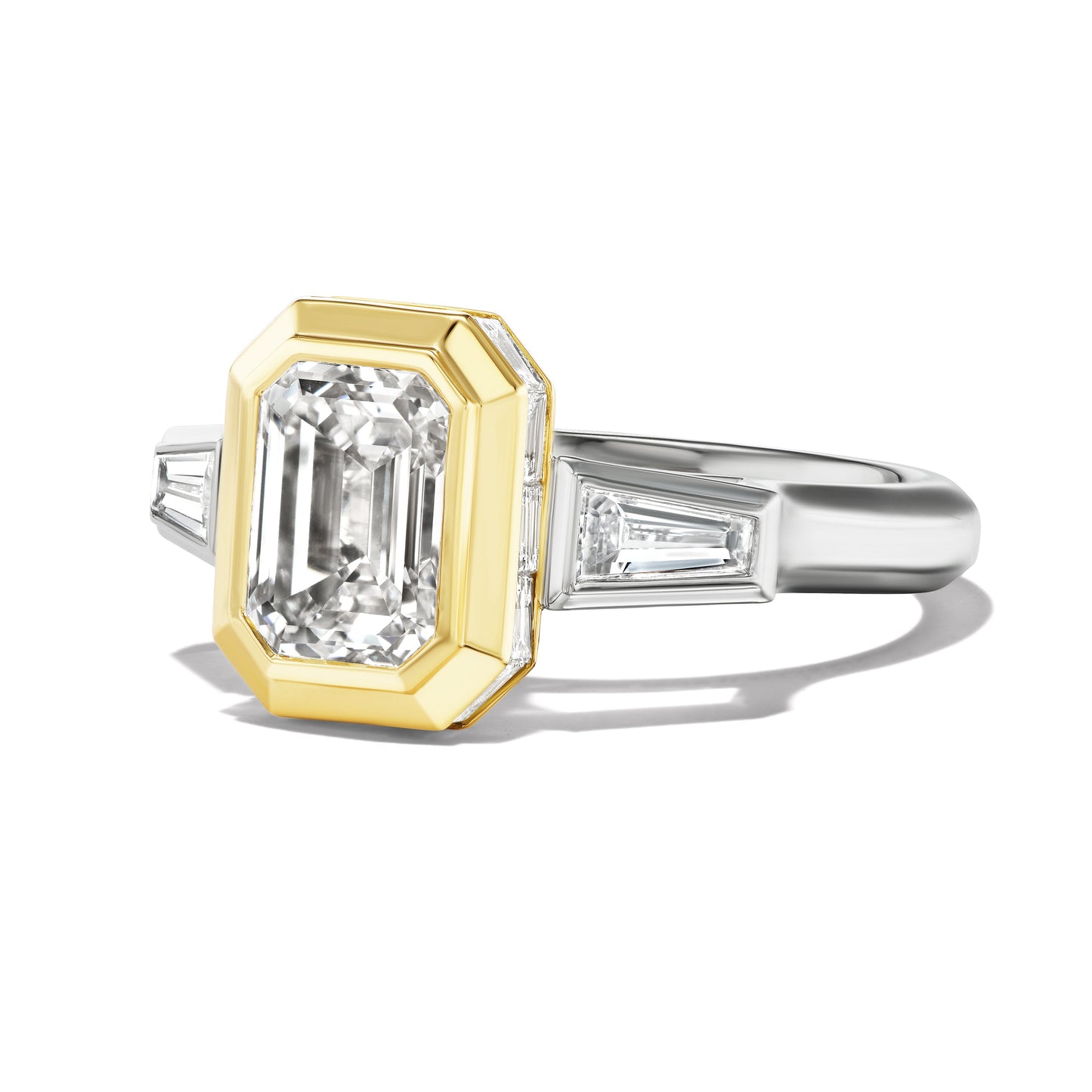 SHIELD BEZEL SET EMERALD CUT ENGAGEMENT RING WITH TAPERED BAGUETTES