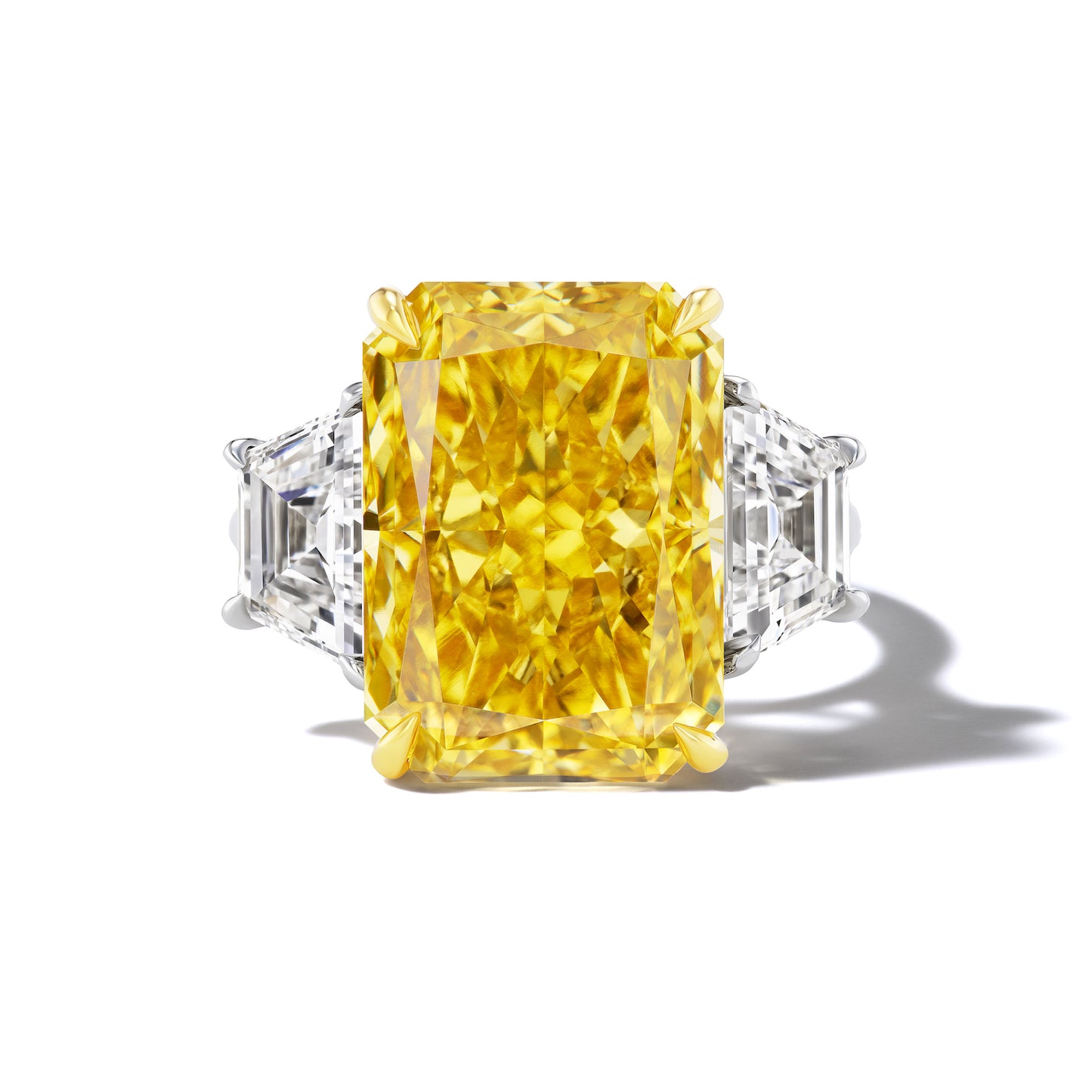 EMERALD CUT DIAMOND ENGAGEMENT RING WITH A TRAPEZOID FLANK THREE PHASES SLIM SETTING IN PLATINUM