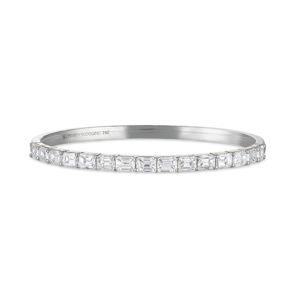 Platinum bracelet with diamond accents on a white background