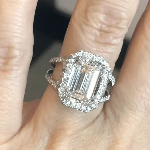 BESPOKE EMERALD CUT DIAMOND ENGAGEMENT RING WITH HALO