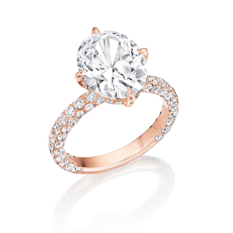 Rose gold engagement ring with a large round diamond center and a pave diamond band shown on a white background.