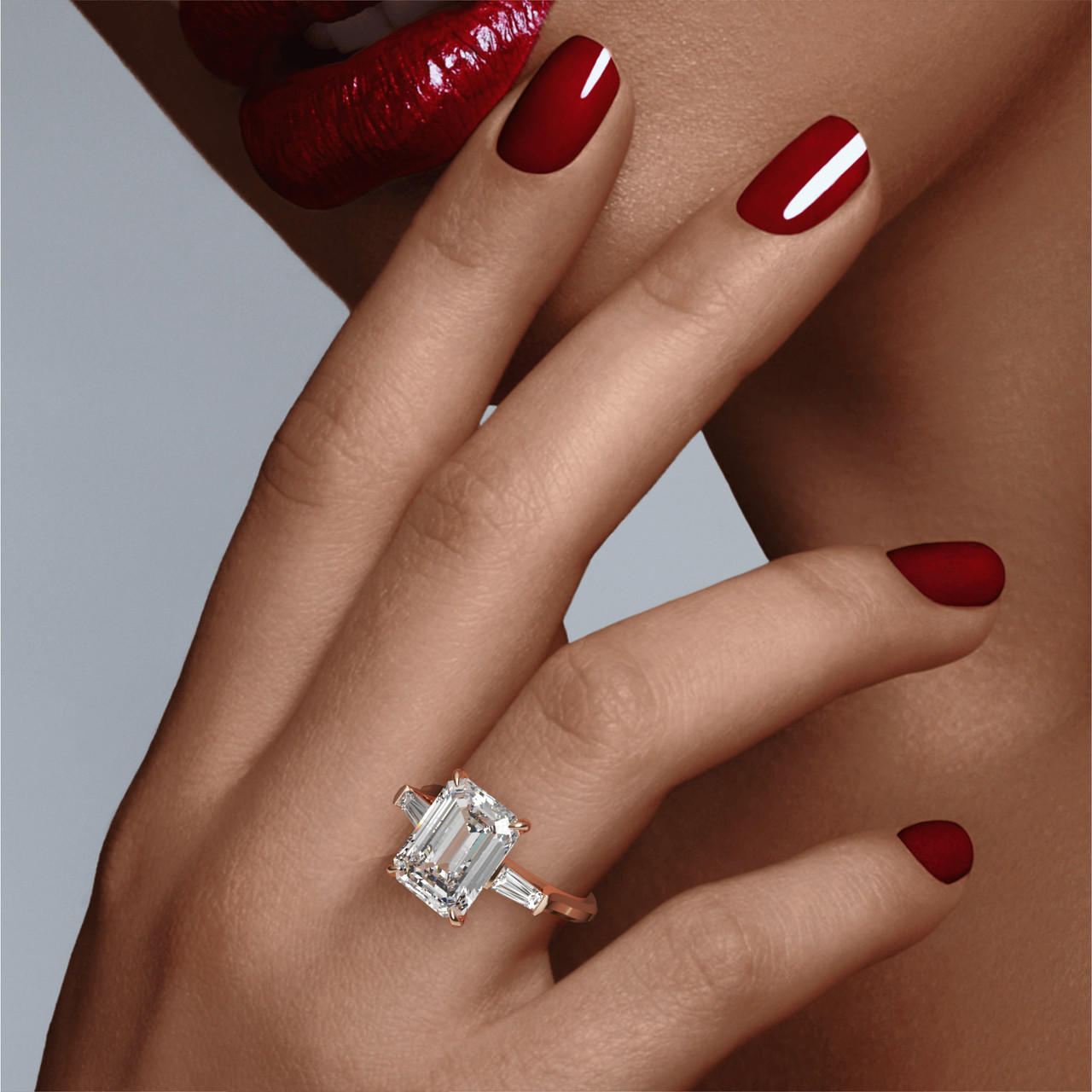 EMERALD CUT DIAMOND ENGAGEMENT RING WITH A BAGUETTE FLANK THREE PHASES SLIM SETTING IN 18K ROSE GOLD