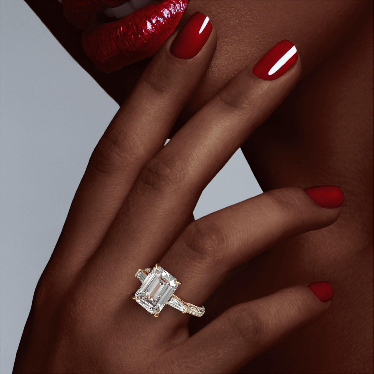 emerald cut diamond engagement ring with a baguette flank three phases triple pave setting in 18k yellow gold