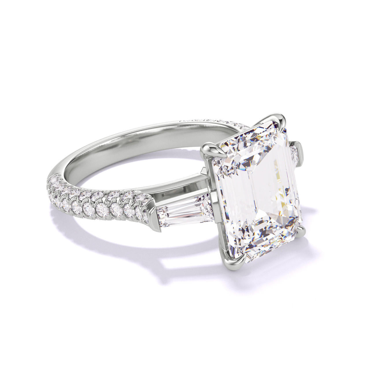 EMERALD CUT DIAMOND ENGAGEMENT RING WITH A BAGUETTE FLANK THREE PHASES TRIPLE PAVE SETTING IN PLATINUM