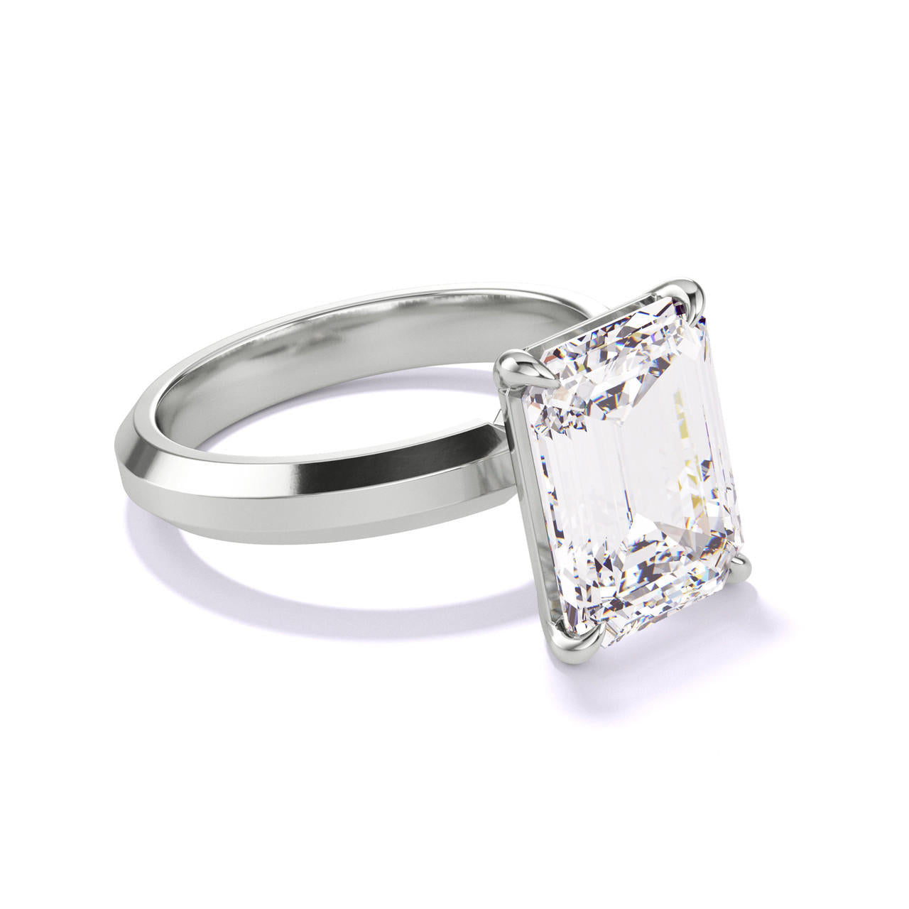 EMERALD CUT DIAMOND ENGAGEMENT RING WITH A CLASSIC 4 PRONG THREE PHASES SETTING IN PLATINUM