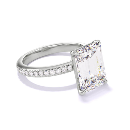 EMERALD CUT DIAMOND ENGAGEMENT RING WITH A CLASSIC 4 PRONG THREE PHASES PAVE SETTING IN PLATINUM