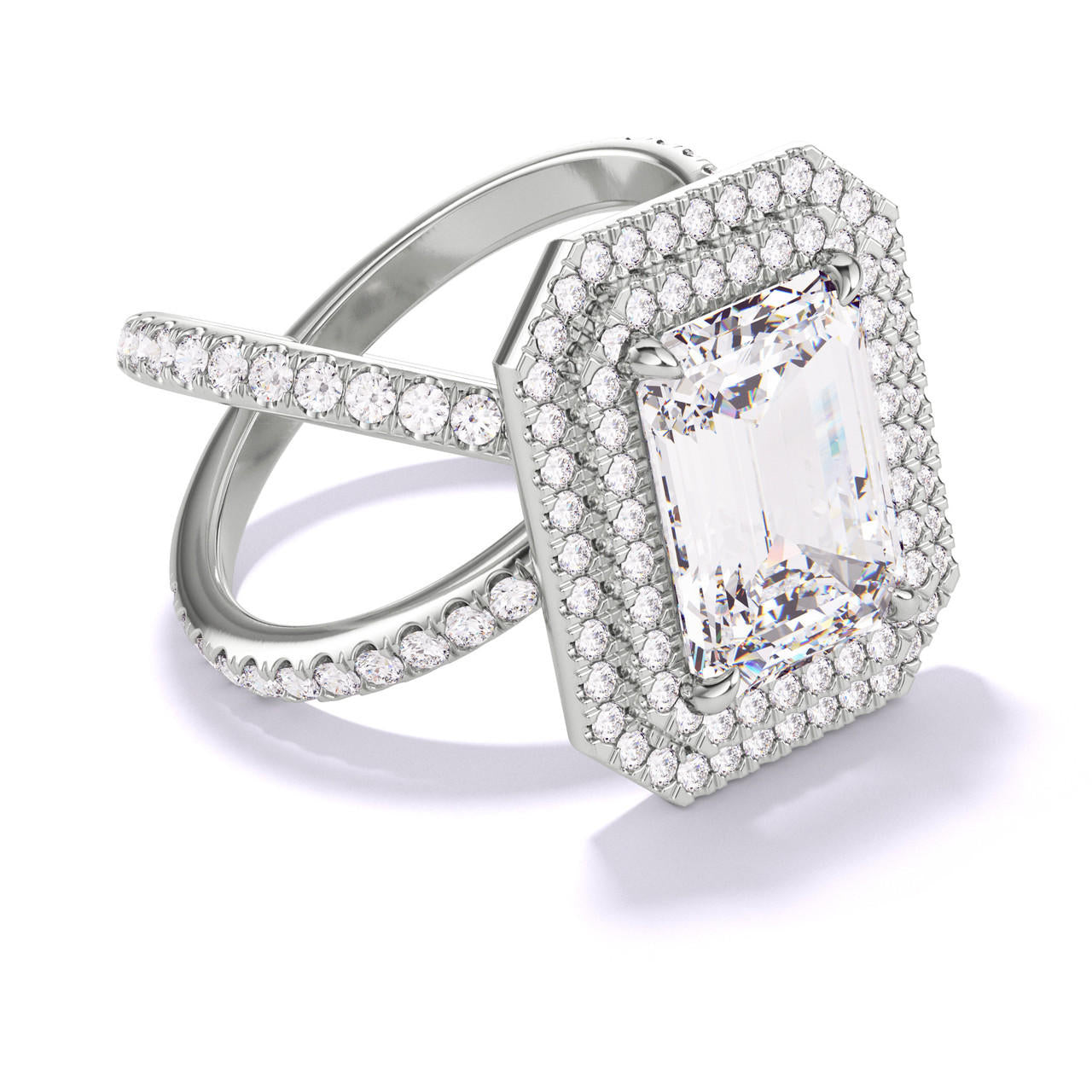 EMERALD CUT DIAMOND ENGAGEMENT RING WITH A DOUBLE HALO AXIS PAVE SETTING IN PLATINUM