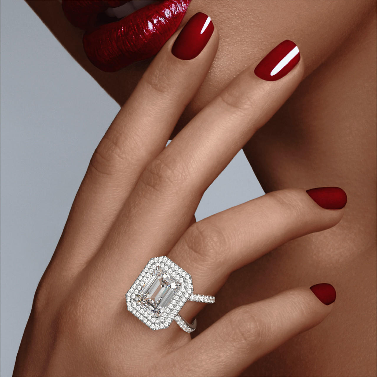 EMERALD CUT DIAMOND ENGAGEMENT RING WITH A DOUBLE HALO AXIS PAVE SETTING IN PLATINUM