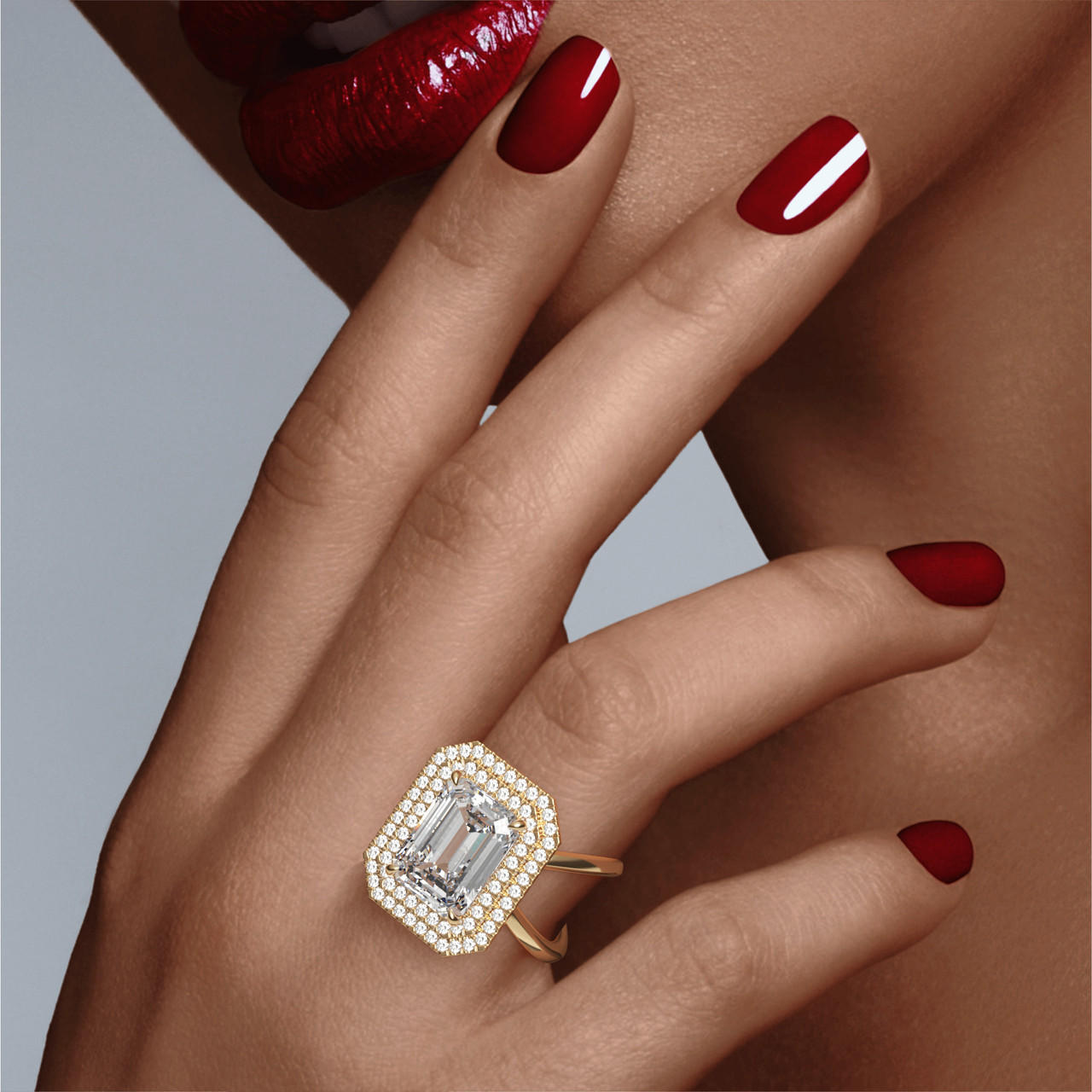 EMERALD CUT DIAMOND ENGAGEMENT RING WITH A DOUBLE HALO AXIS SETTING IN 18K YELLOW GOLD