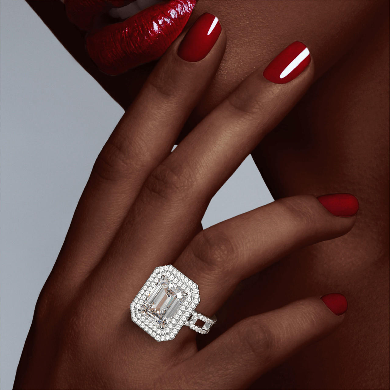 Platinum Emerald Cut Double Halo Engagement Ring on a Pave 8 Link Band on hand