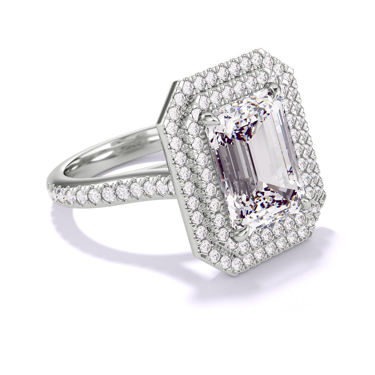 EMERALD CUT DIAMOND ENGAGEMENT RING WITH A DOUBLE HALO THREE PHASES PAVE SETTING IN PLATINUM