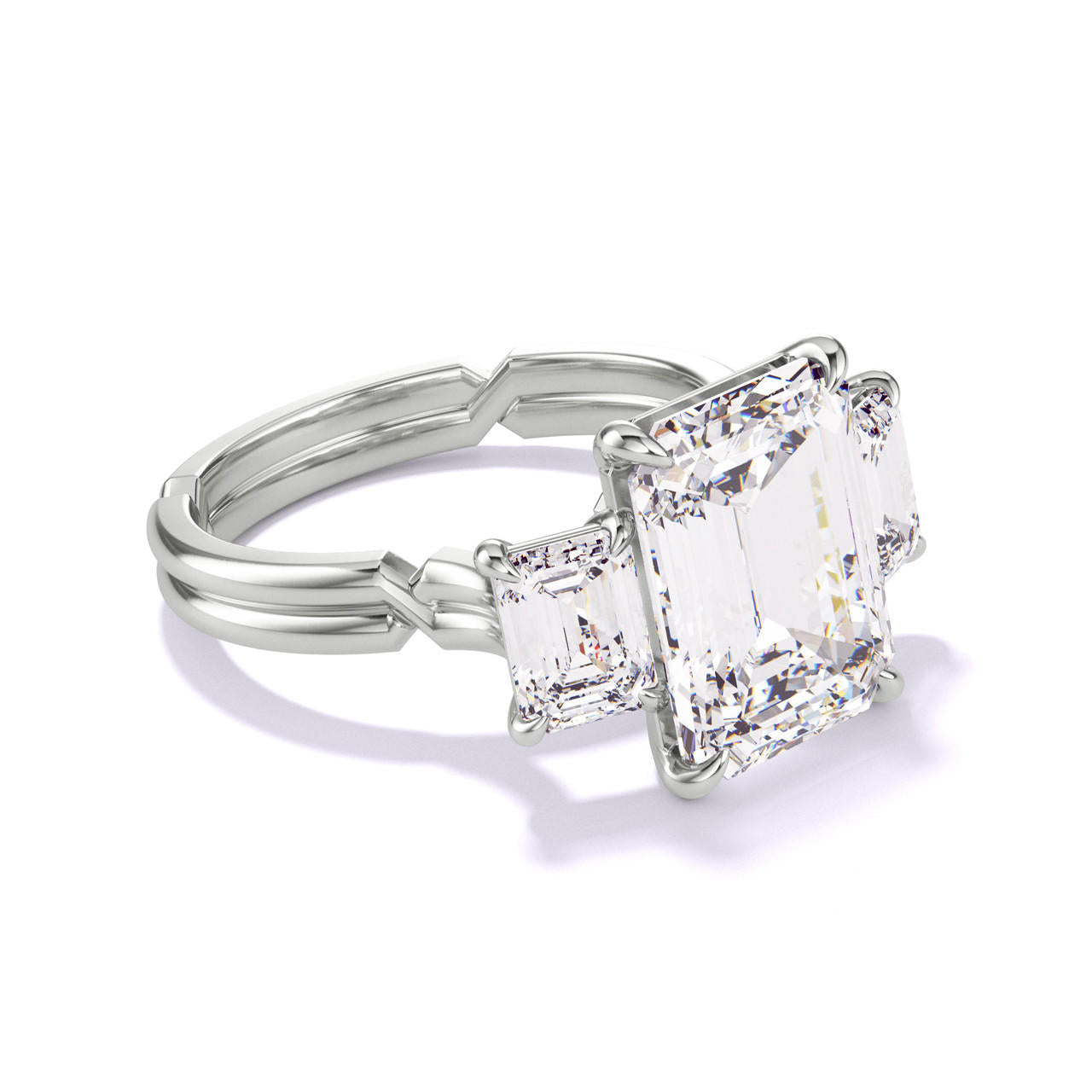 EMERALD CUT DIAMOND ENGAGEMENT RING WITH A THREE STONE CHANCE SETTING IN PLATINUM