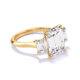 Gold Emerald Cut Three Stone Engagement Ring on a Slim Three Phases Band