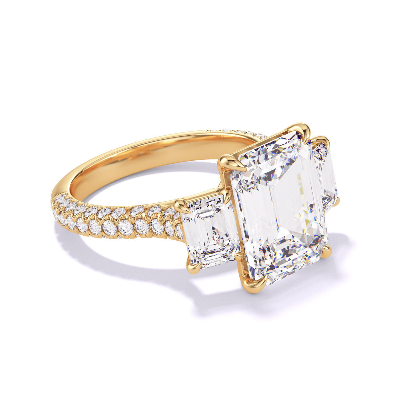 EMERALD CUT DIAMOND ENGAGEMENT RING WITH A THREE STONE THREE PHASES TRIPLE PAVE SETTING IN 18K YELLOW GOLD