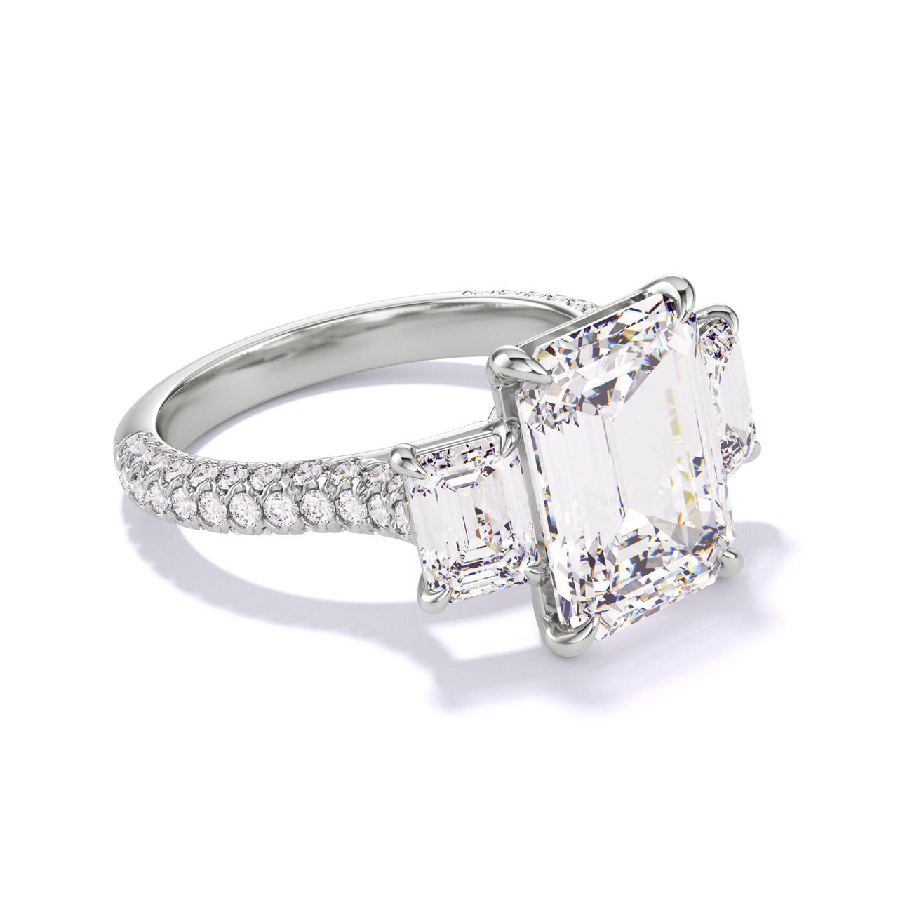 Platinum Emerald Cut Three Stone Engagement Ring on a Pave Three Phases Band
