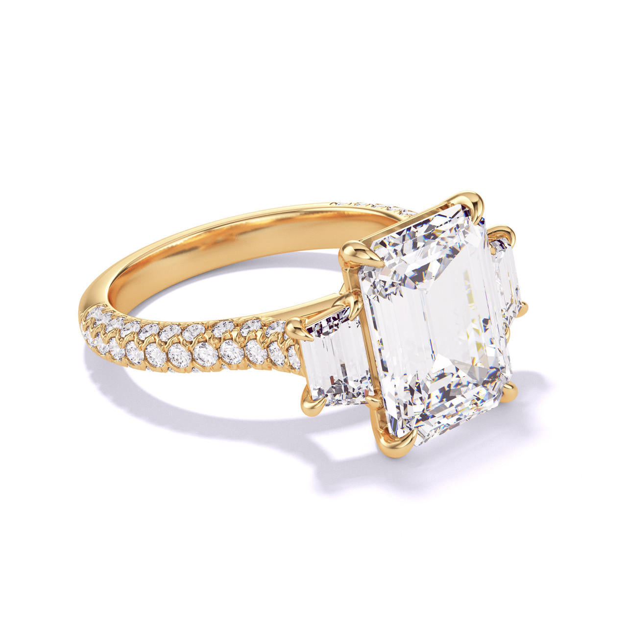 EMERALD CUT DIAMOND ENGAGEMENT RING WITH A TRAPEZOID FLANK THREE PHASES TRIPLE PAVE SETTING IN 18K YELLOW GOLD