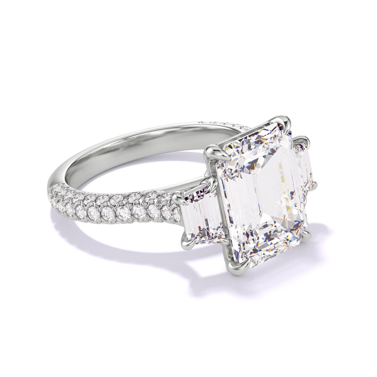 EMERALD CUT DIAMOND ENGAGEMENT RING WITH A TRAPEZOID FLANK THREE PHASES TRIPLE PAVE SETTING IN PLATINUM