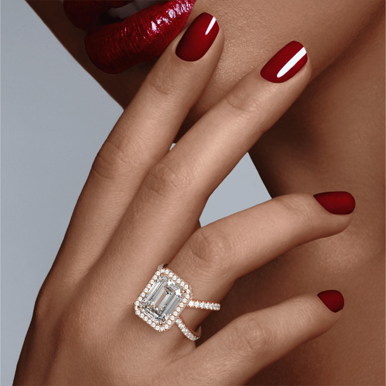 EMERALD CUT DIAMOND ENGAGEMENT RING WITH A WRAPPED HALO AXIS PAVE SETTING IN 18K ROSE GOLD