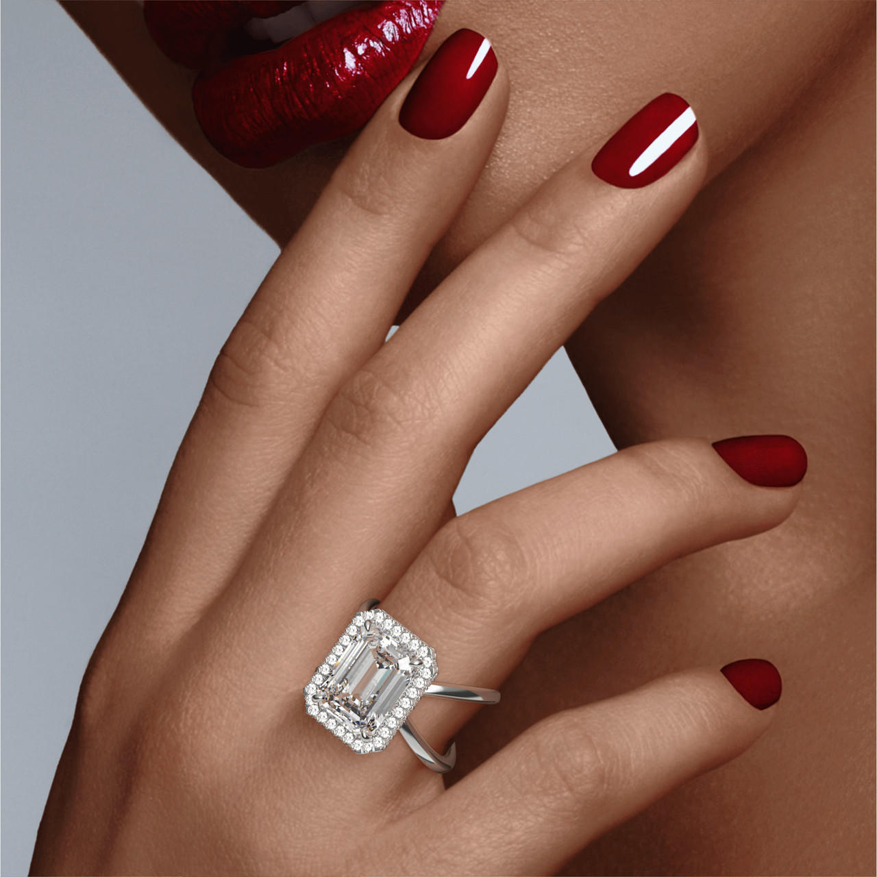 EMERALD CUT DIAMOND ENGAGEMENT RING WITH A WRAPPED HALO AXIS SETTING IN PLATINUM