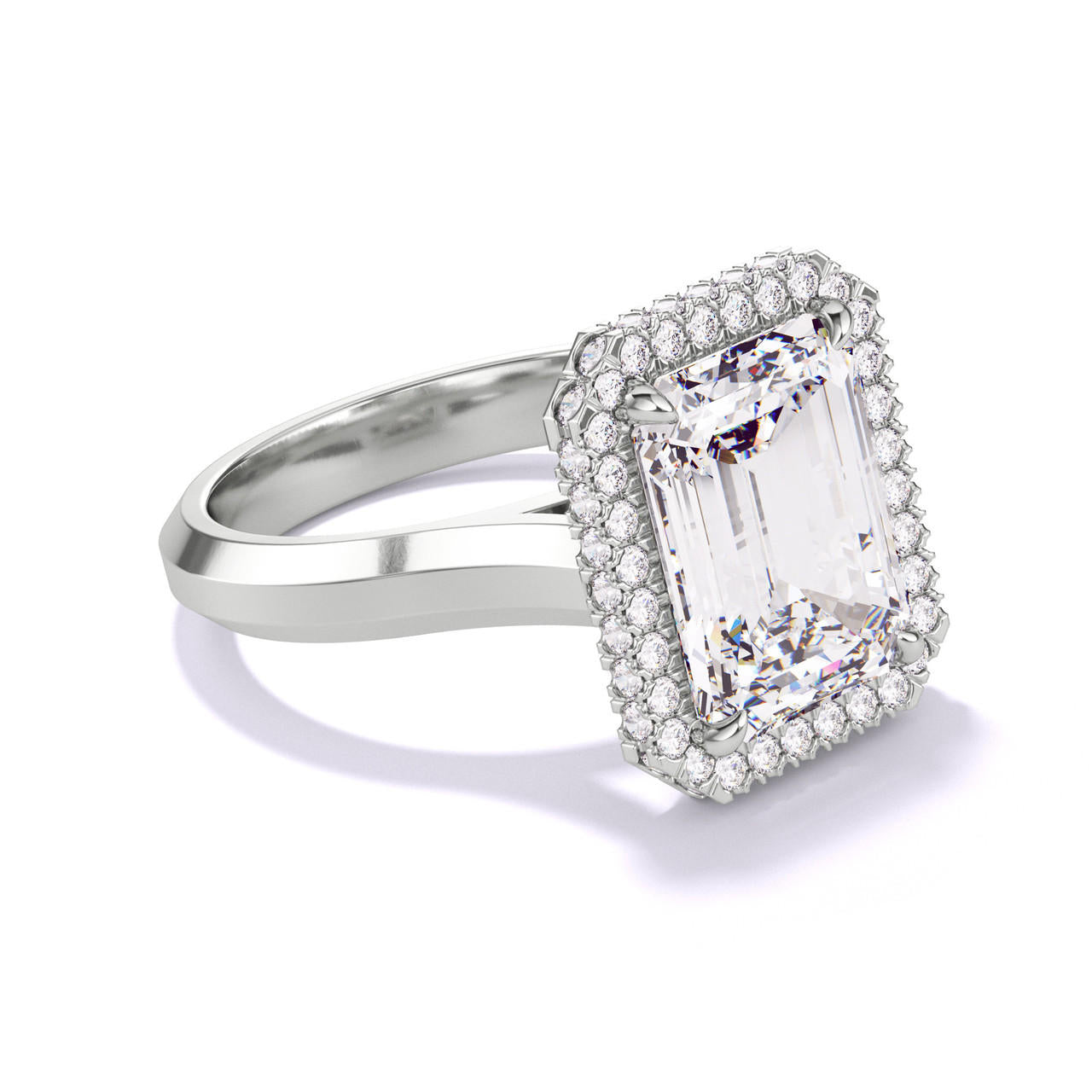 EMERALD CUT DIAMOND ENGAGEMENT RING WITH A WRAPPED HALO THREE PHASES SETTING IN PLATINUM