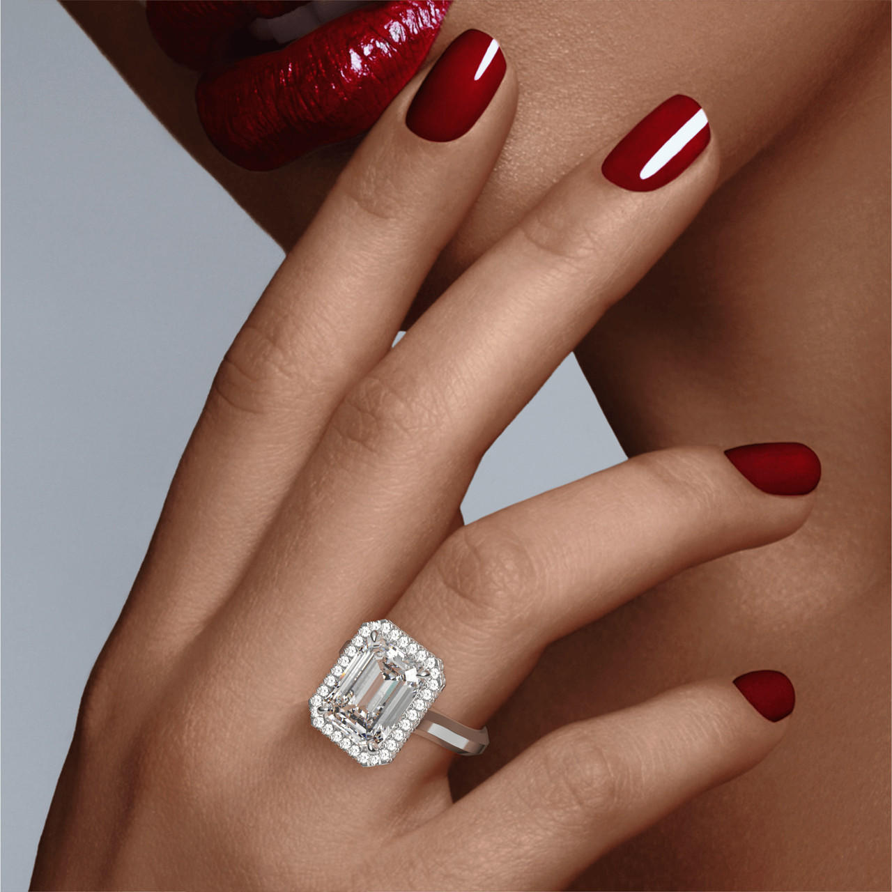 EMERALD CUT DIAMOND ENGAGEMENT RING WITH A WRAPPED HALO THREE PHASES SETTING IN PLATINUM