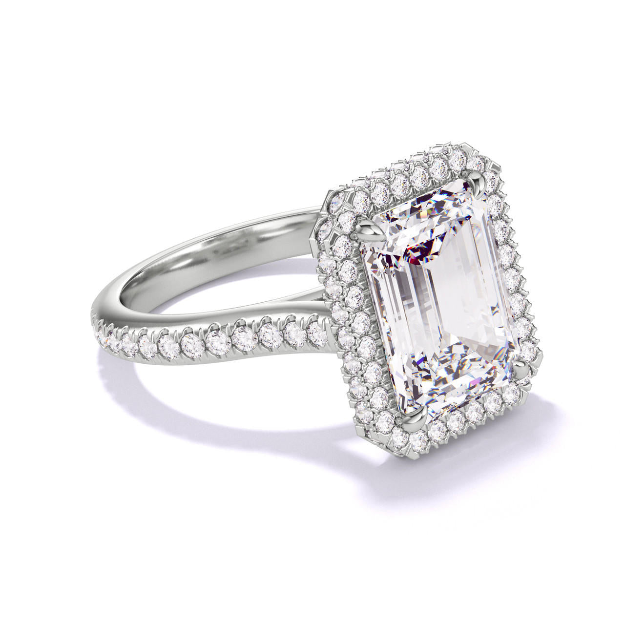 EMERALD CUT DIAMOND ENGAGEMENT RING WITH A WRAPPED HALO THREE PHASES PAVE SETTING IN PLATINUM