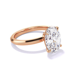 A side view of Oval Cut Diamond Engagement Ring with a Classic 4 Prong Three Phases Slim Setting in 18K Rose Gold.
