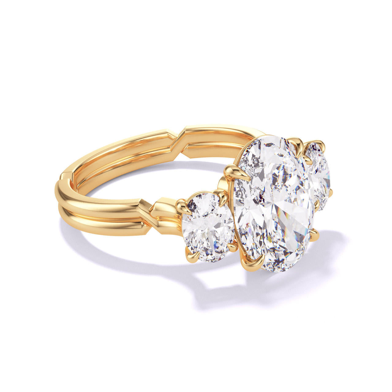 OVAL CUT DIAMOND ENGAGEMENT RING WITH A THREE STONE CHANCE SETTING IN 18K YELLOW GOLD