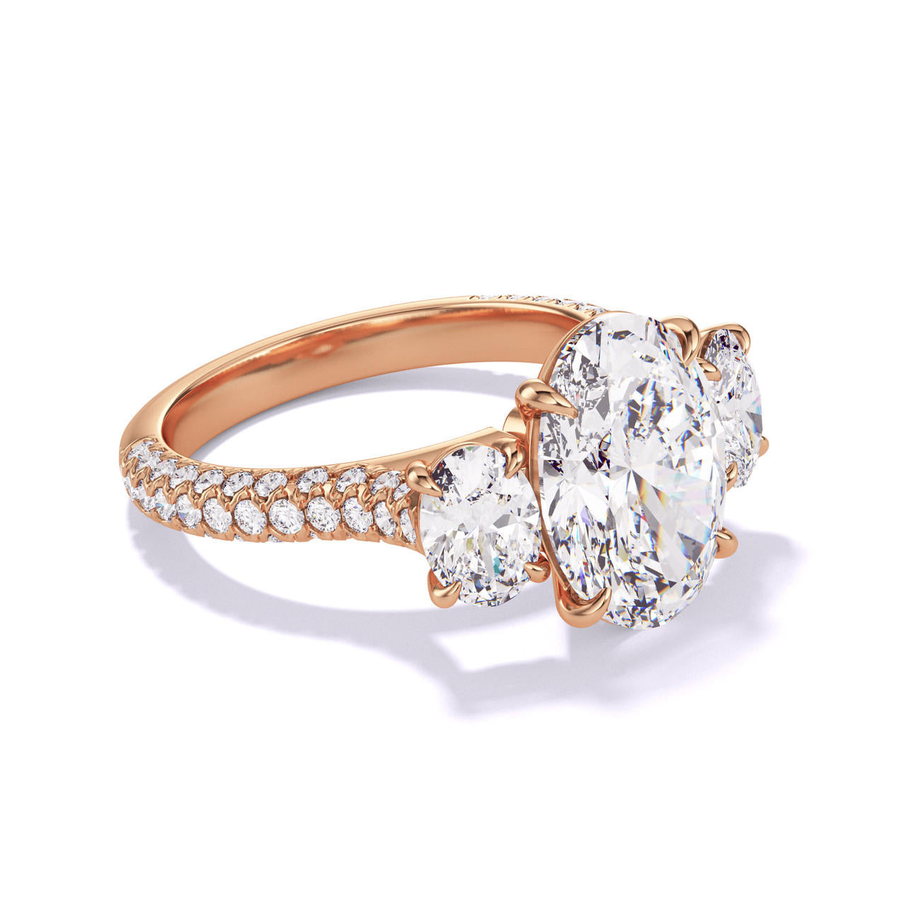 OVAL CUT DIAMOND ENGAGEMENT RING WITH A THREE STONE THREE PHASES TRIPLE PAVE SETTING IN 18K ROSE GOLD