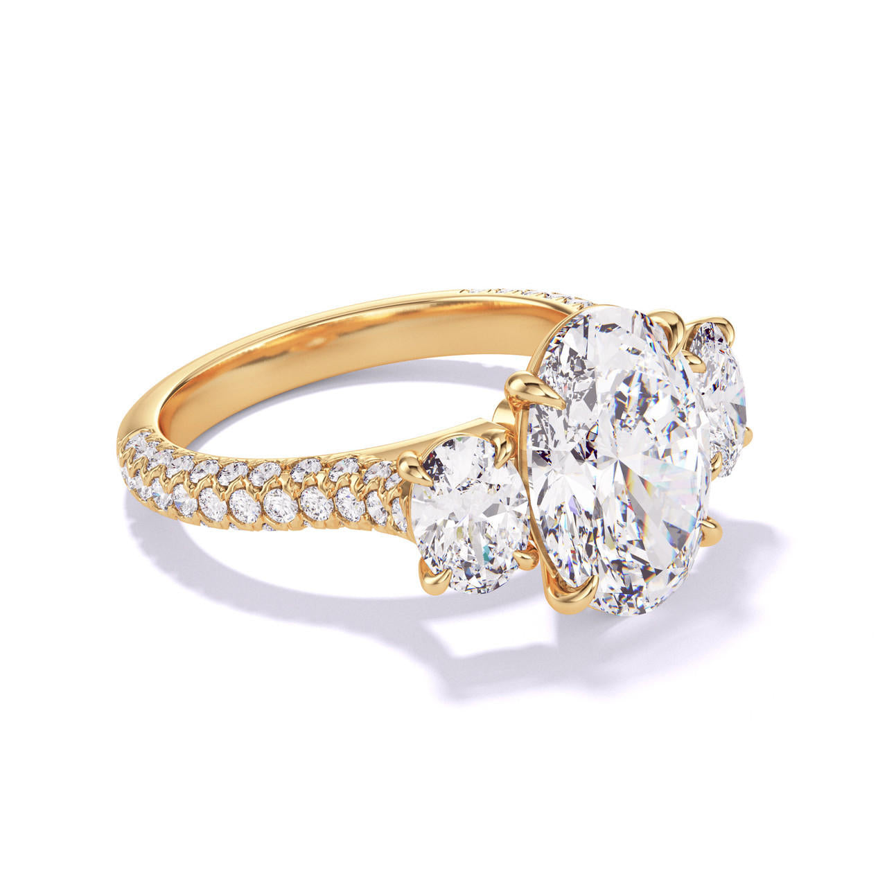 OVAL CUT DIAMOND ENGAGEMENT RING WITH A THREE STONE THREE PHASES TRIPLE PAVE SETTING IN 18K YELLOW GOLD