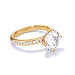 Round cut diamond engagement ring with a compass 4 prong three phases pave setting in 18k yellow gold