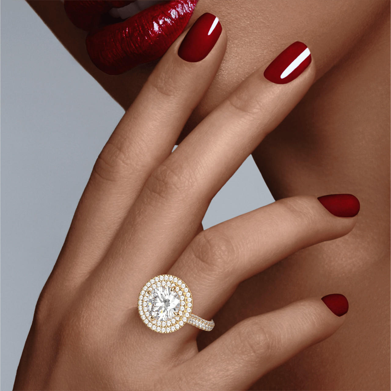 Gold Round Engagement Ring with a Double Halo Three Phases Triple Pave Setting on hand