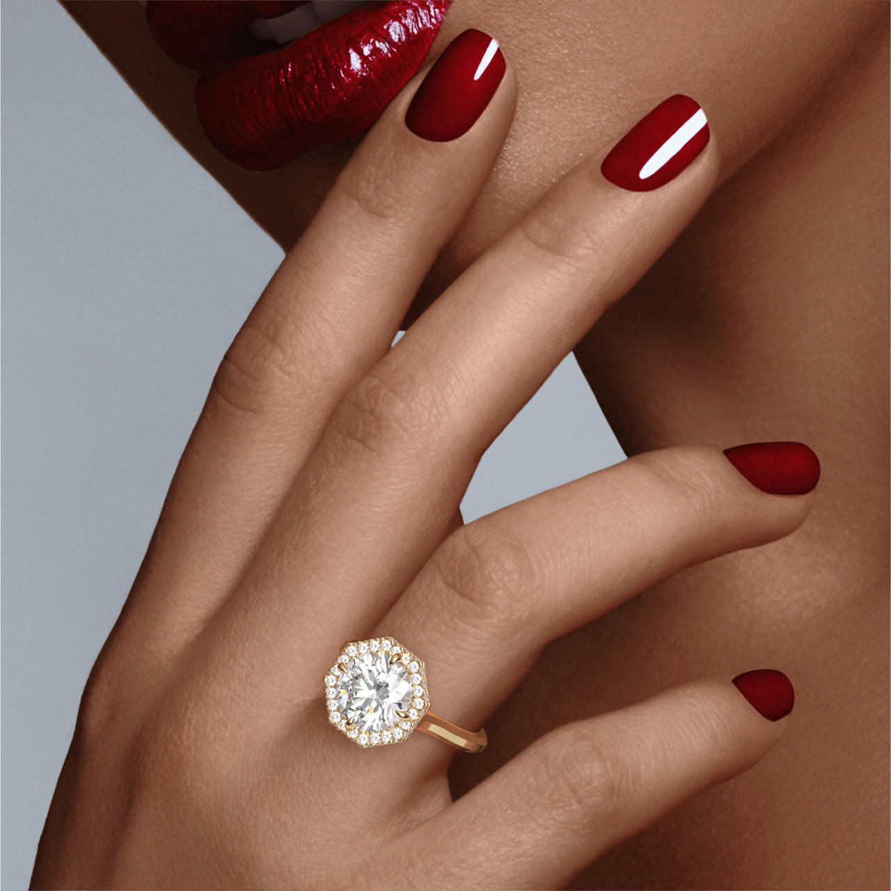 Gold Round Engagement Ring with an Octagon Halo Slim Three Phases Setting on hand