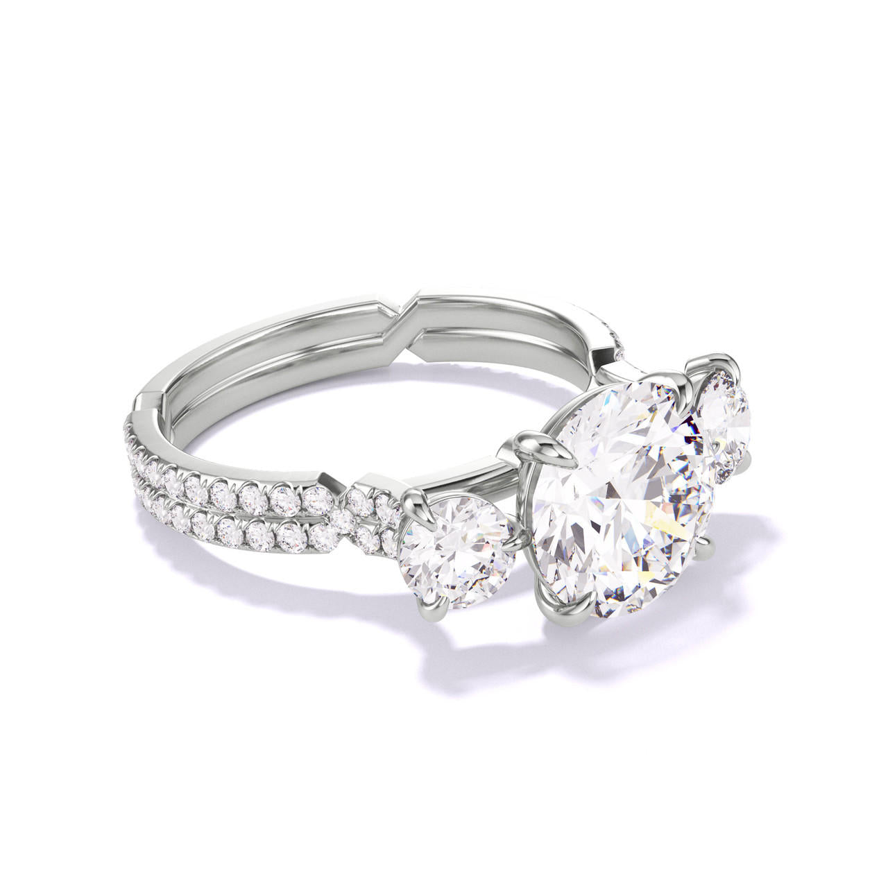 ROUND CUT DIAMOND ENGAGEMENT RING WITH A THREE STONE CHANCE PAVE SETTING IN PLATINUM