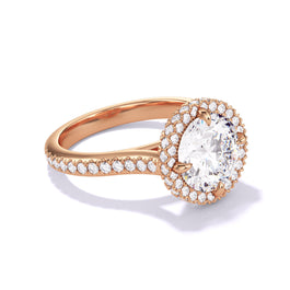 An 18K Rose Gold Round Cut Diamond Engagement Ring with a Wrapped Halo 3 Phases Pave Setting.