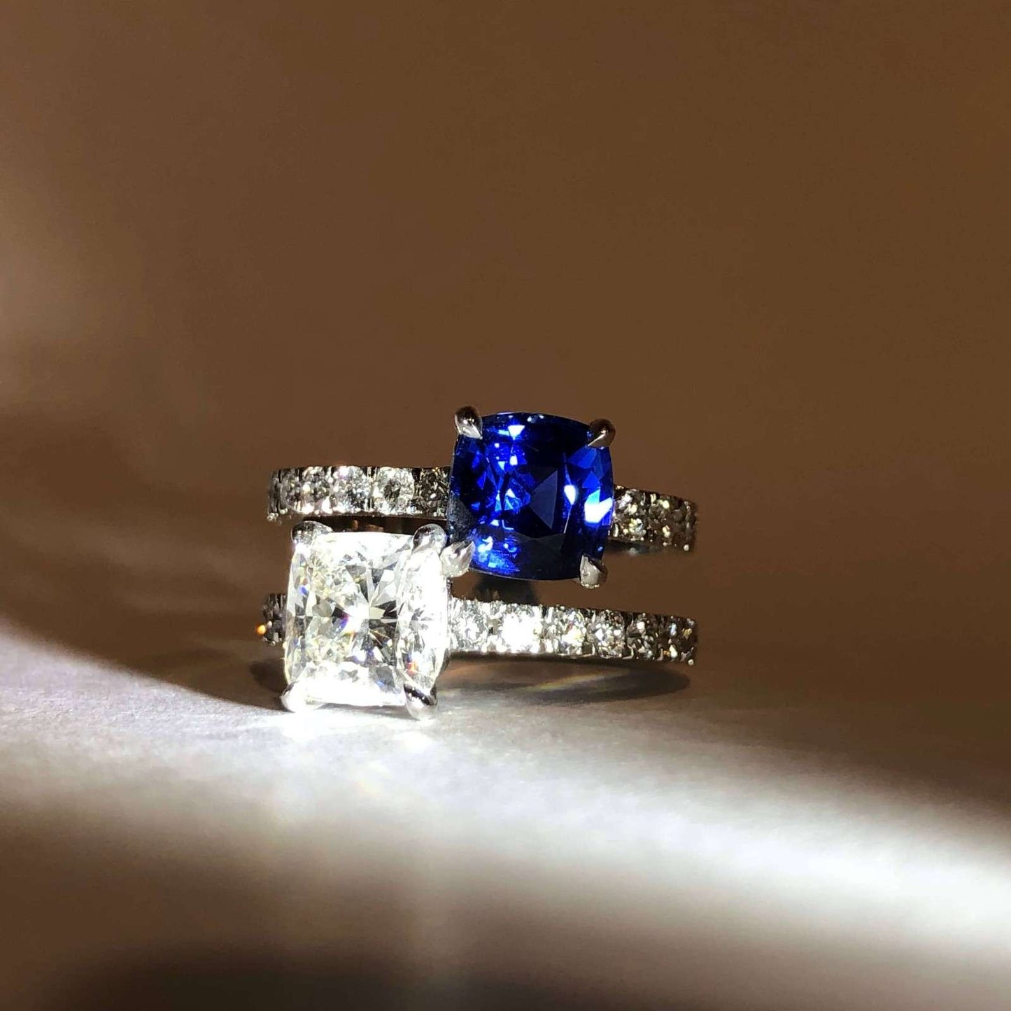 Bespoke cushion cut sapphire and diamond toi et moi engagement ring.