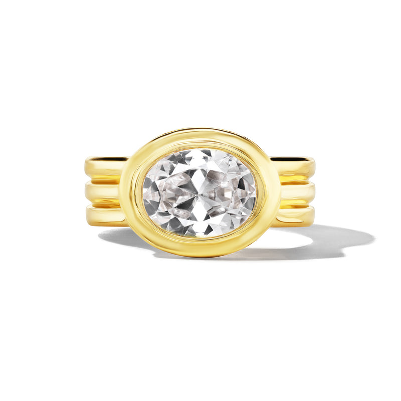 Front view of the Triple Trumpet Bezel Set East West Oval Diamond Engagement Ring in yellow gold.