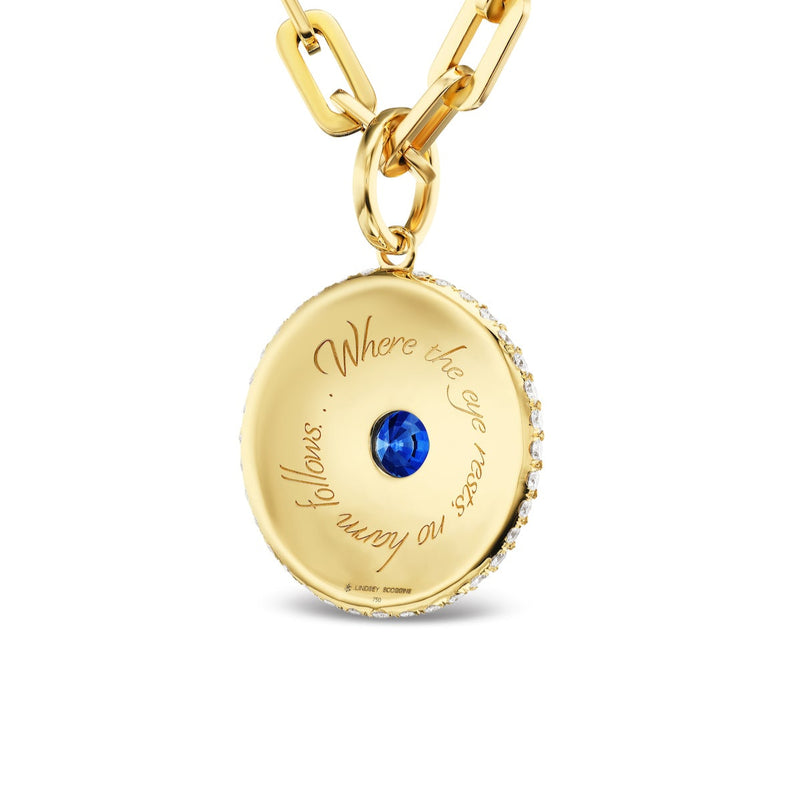 Evil eye medallion necklace with blue and white enamel on a gold chain.