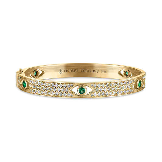 diamond and emerald evil eye bangle in 18k yellow gold