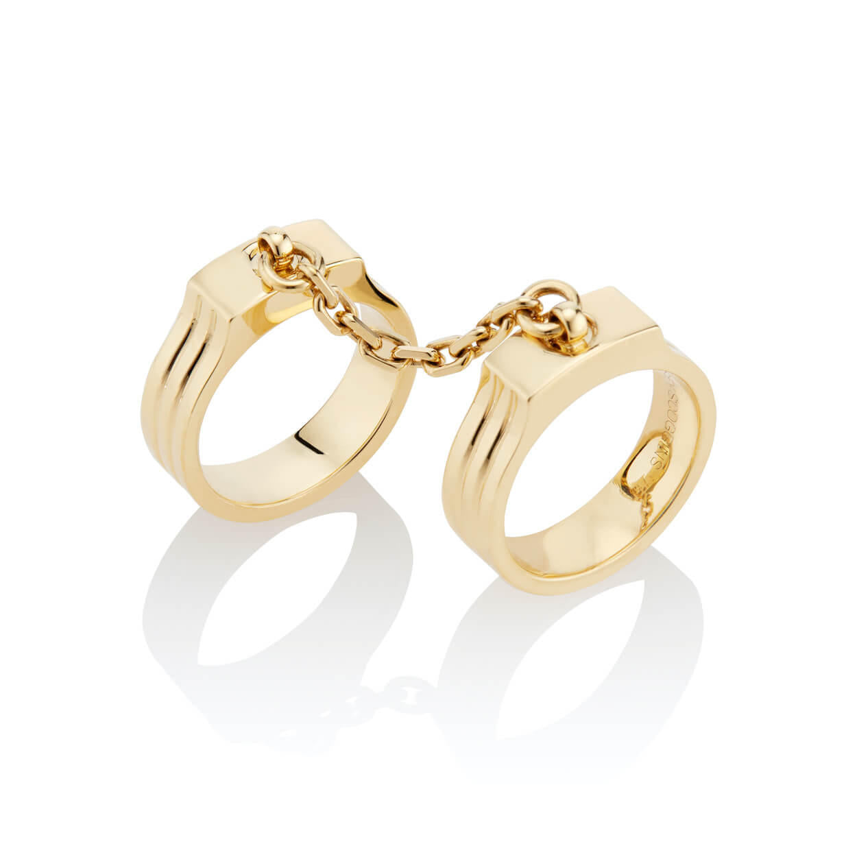 oath double finger ring with chain set in yellow gold with chain detail stacked