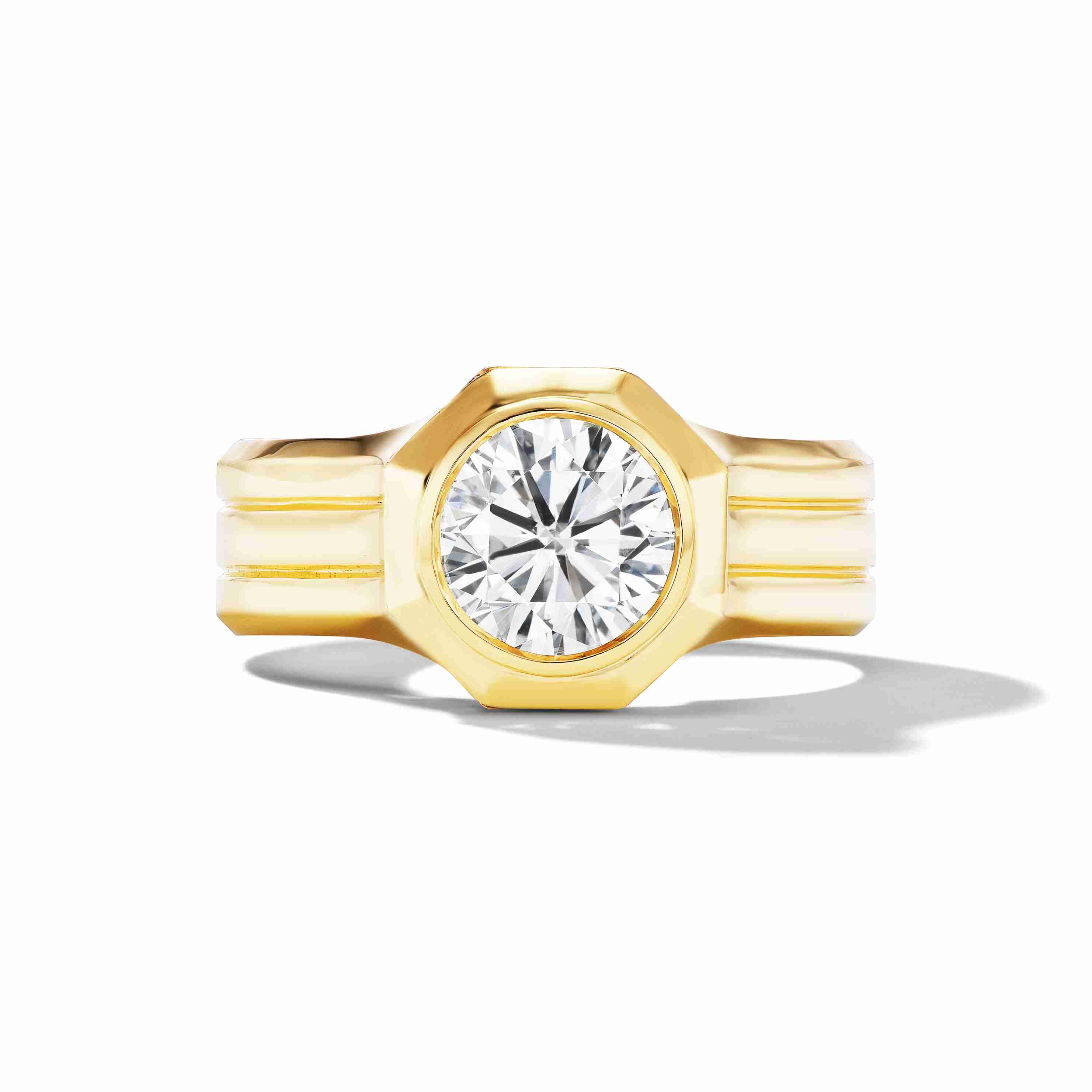 Front view of a yellow gold engagement ring featuring a wide band and an octagonal-cut diamond at the center.