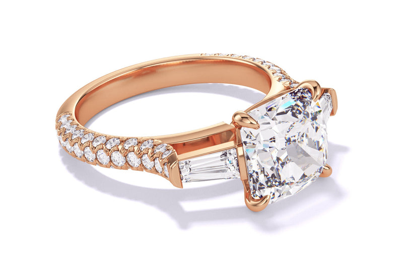 Rose gold ring with a cushion-cut diamond, tapered baguettes, and a pavé-set band.