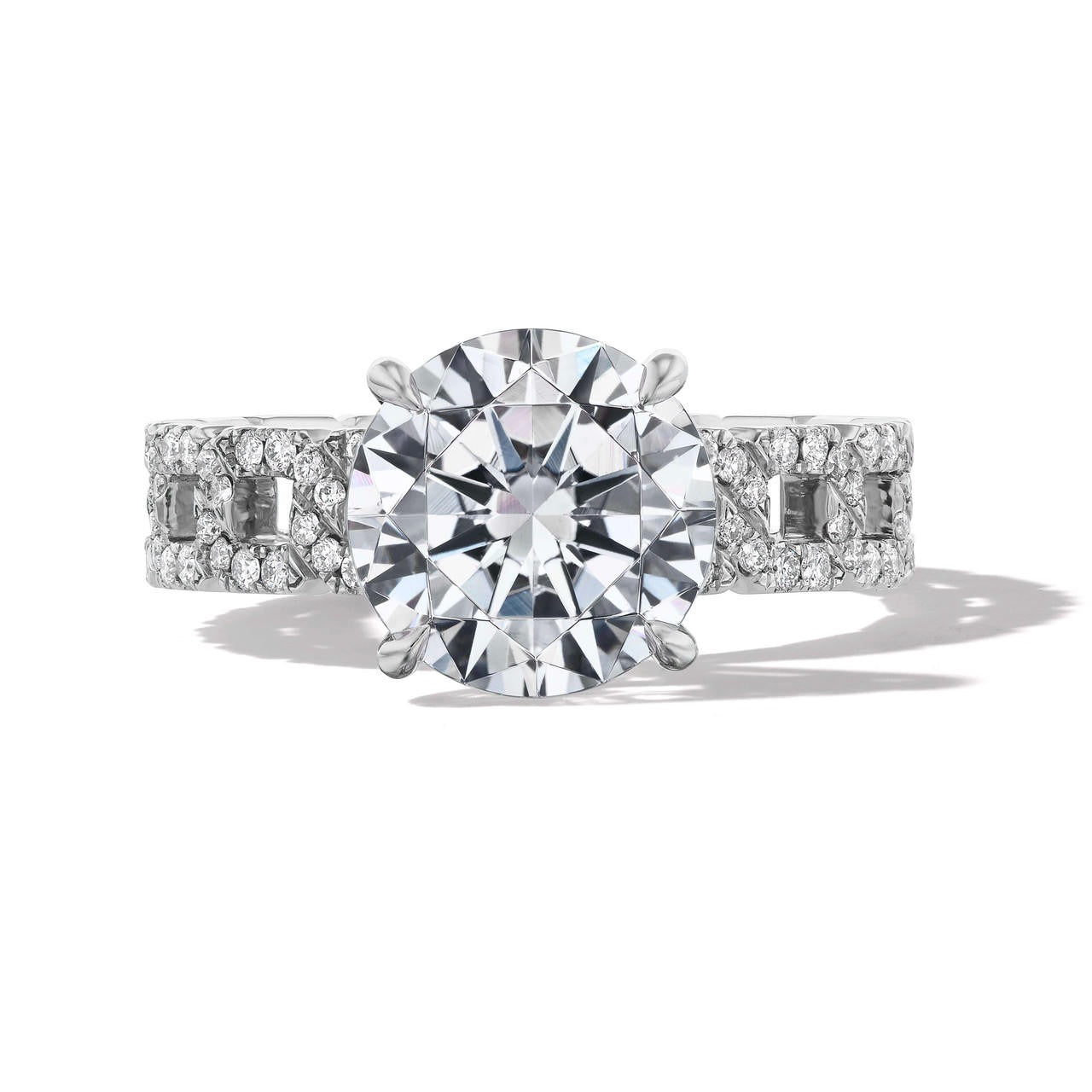 Platinum Round Diamond Solitaire Engagement Ring with a four prong setting on a pave 16 link band