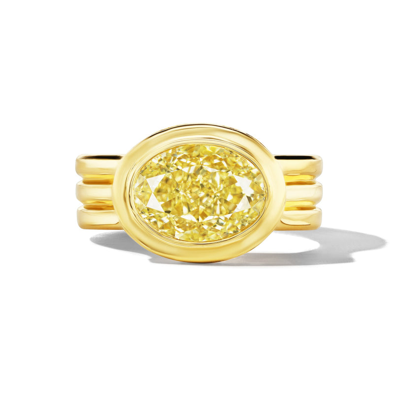 Yellow diamond shield-style ring with three trumpet-shaped side stones on a simple background.