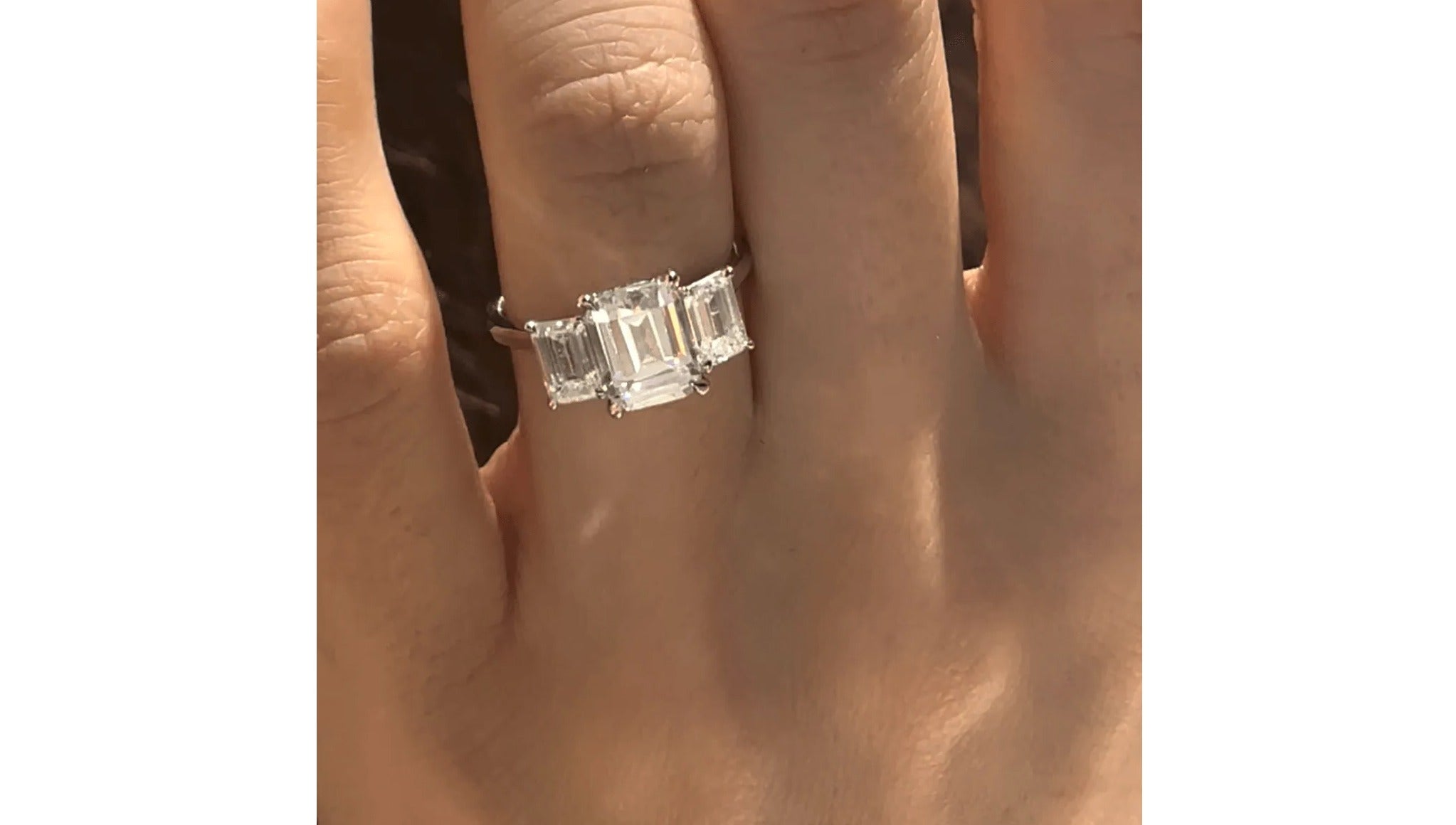 emerald cut three stone engagement ring