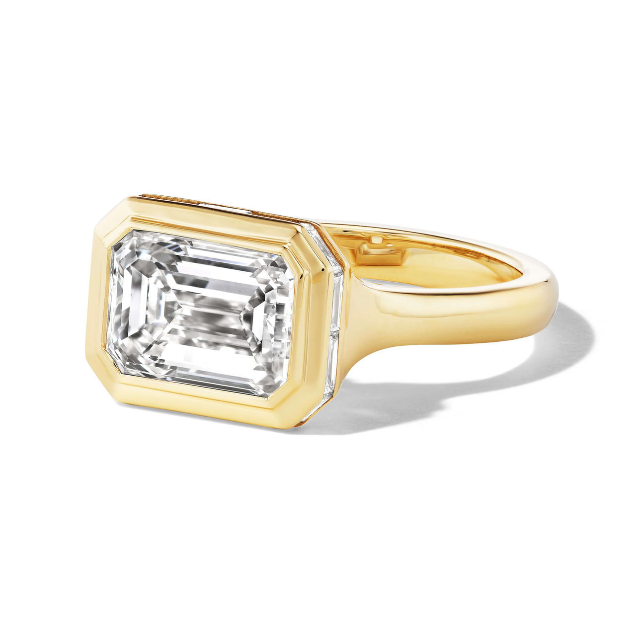Bezel set east west emerald cut diamond ring