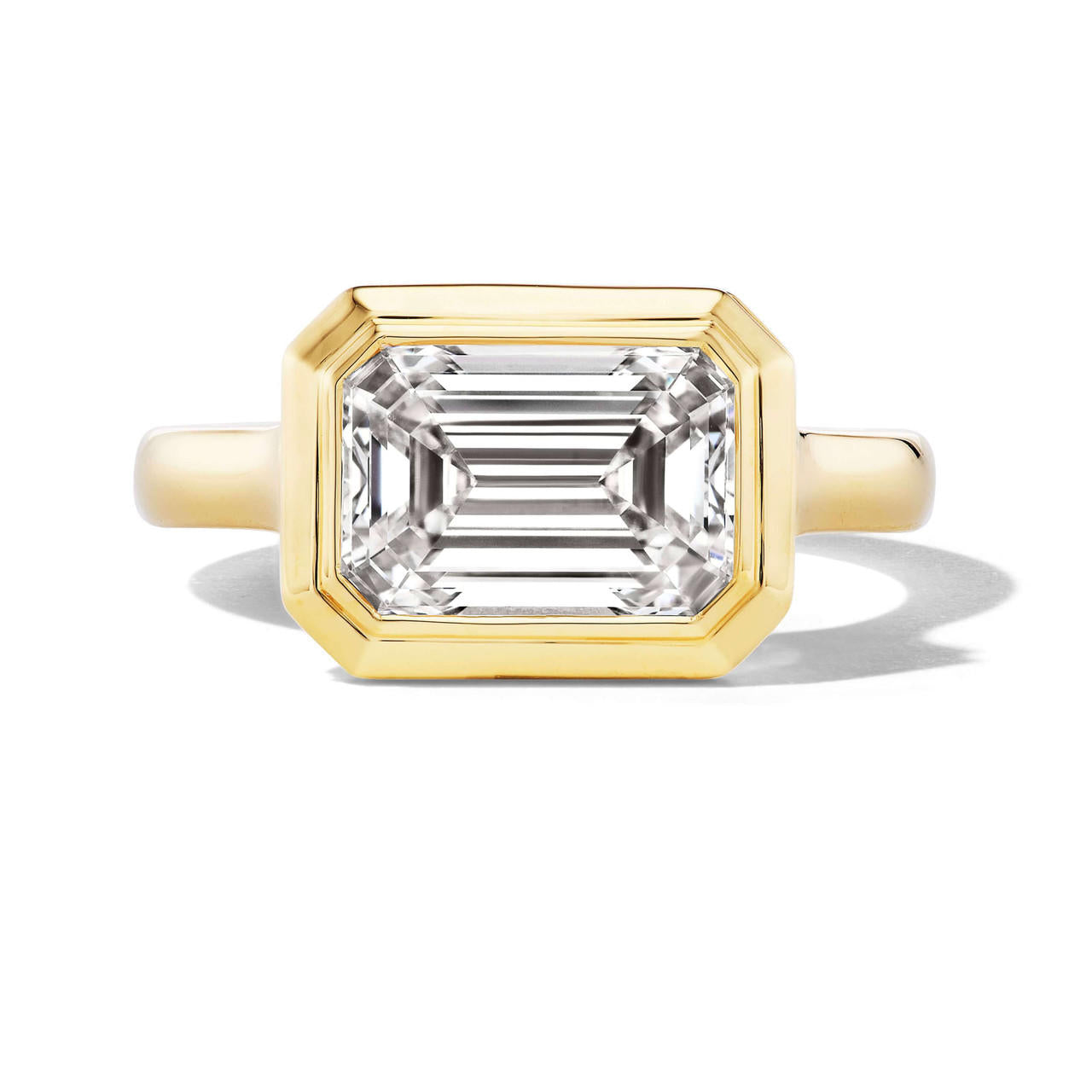 Bezel set east west emerald cut diamond ring